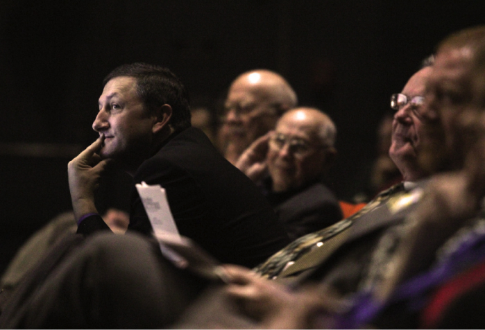 Men in suits sitting in a row, one leans forward, interested, by South Arkansas University, Creative Commons on Flickr